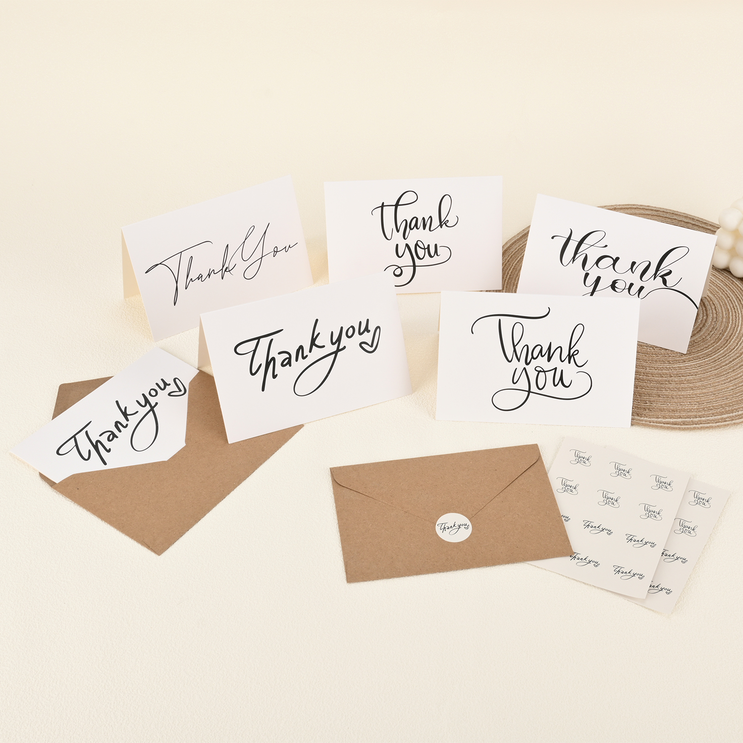 Assorted printed thank-you cards with kraft envelopes